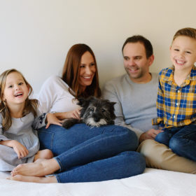 Lifestyle family portrait in bed with dog