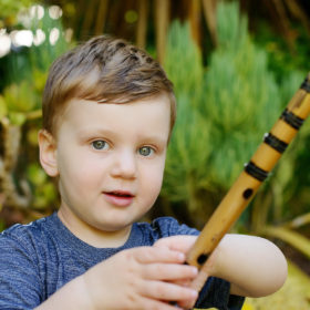 Little boy holding stick close up
