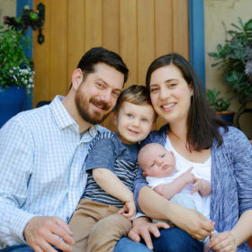 Lifestyle family portrait while sitting on porch steps in Sacramento home