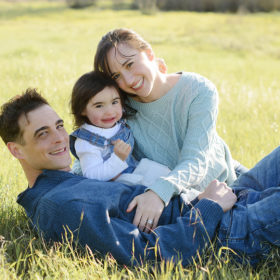 Family photo with toddler on grass in natural light in West Sacramento