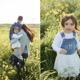 Toddler girl wearing yellow flower crown in middle of green field in West Sacramento