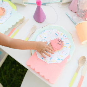 Detail of girl getting icecream cookie on confetti paper plate
