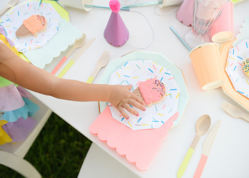Detail of girl getting icecream cookie on confetti paper plate