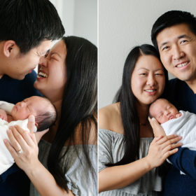 Mom and dad smile while holding newborn baby girl at home