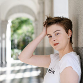 Teen girl touching her hair and leaning against wall in State Capitol
