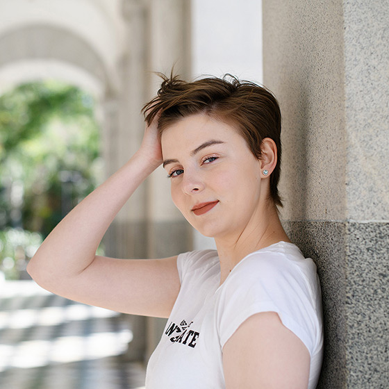 High school senior leaning against wall in State Capitol building