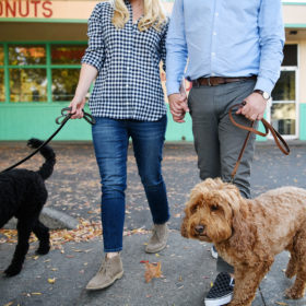Couple wearing flannel and boots walking their dogs outside of Maries Donuts in Sacramento