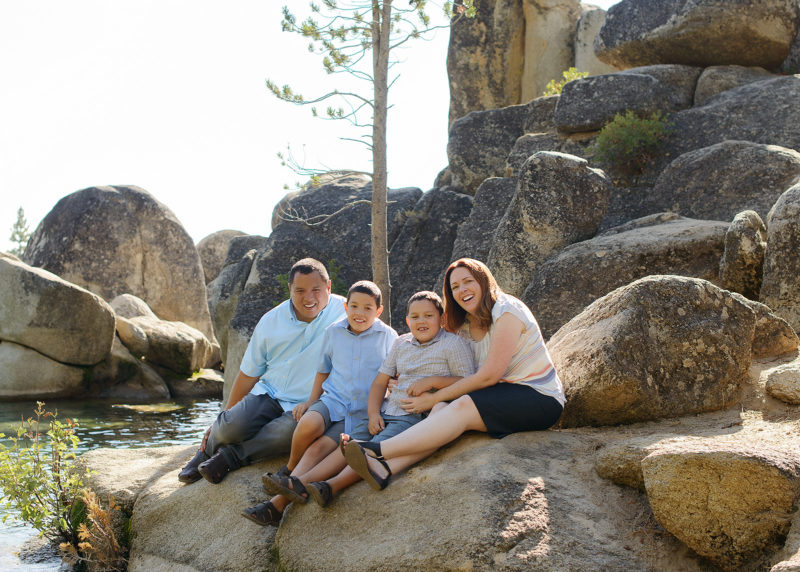 Family portrait on smooth rocks by Lake Tahoe shore