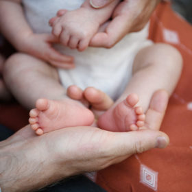 Newborn baby boy close up of feet and hands in Sacramento home