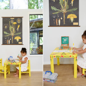Toddler girl coloring on yellow kids table under botanical print in Mendocino home