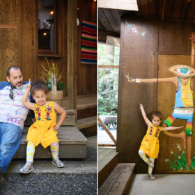 Daughter being silly and copying mural on home and striking a pose with dad in Mendocino home