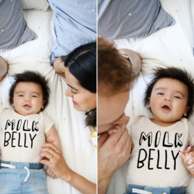 Baby boy lying in bed with mom and dad wearing a Milk Belly onesie in Sacramento home