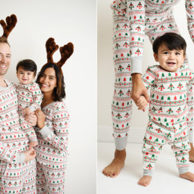 Mom and dad hold baby boy wearing matching Christmas pajamas and reindeer antlers in studio
