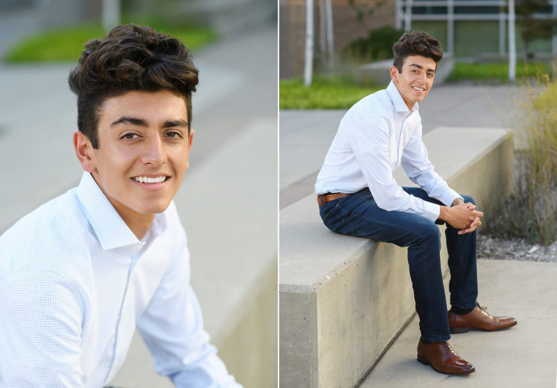 Senior boy sitting on concrete outside of Oak Ridge High School in El Dorado Hills smiling