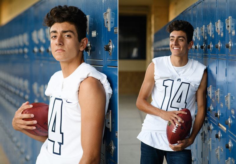 Senior boy wearing football jersey and holding football in front of blue lockers in Oak View High School El Dorado HIlls