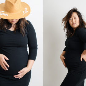 Maternity photo of pregnant Asian woman in black dress holding baby bump in Sacramento studio white wall
