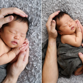 Newborn baby girl sleeping on gray marled blanket while dad holds her head