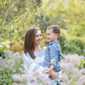 Mom holding son and smiling in the middle of wildflowers in Land Park Sacramento