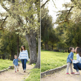 Mom and son walking through Land Park among tall Oak trees