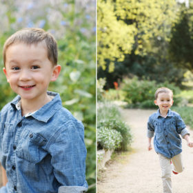 Little boy wearing denim shirt smiling directly at camera and running with trees in background in Land Park Sacramento