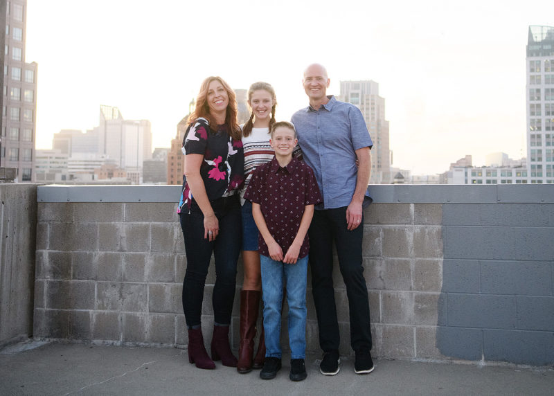 Family photo overlooking Sacramento skyline on a rooftop
