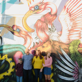 Family photo in front of Mateus Bailon mural in midtown Sacramento