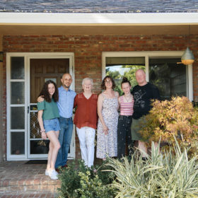 Family reunion portrait in front of house entrance in Sacramento