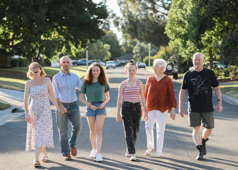 Family walking down the street and holding hands in Sacramento