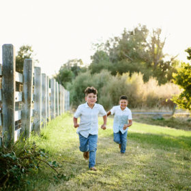 Brothers running in grass in Sacramento