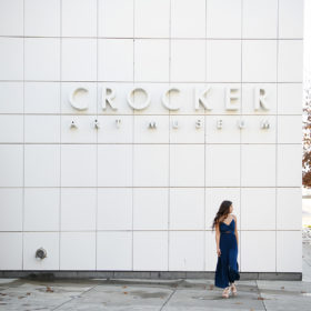 High school senior girl posing in front of Crocker Art Museum sign in Sacramento