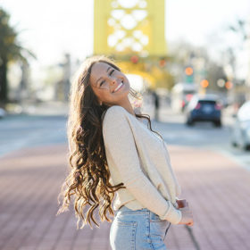 Senior girl posing in front of Tower Bridge in Sacramento