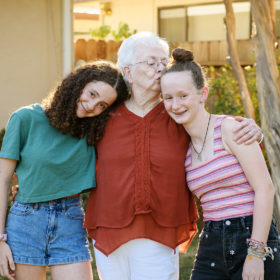 Grandma kissing her granddaughters as they reunite in Sacramento