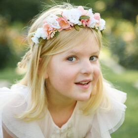 Close up of girl wearing flower crown in McKinley Park Rose Garden Sacramento