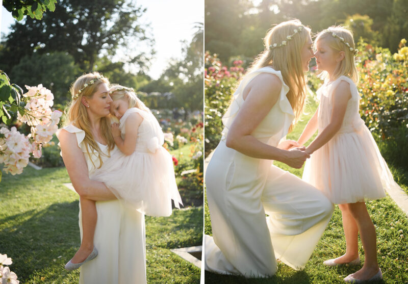Mom holding her daughter and kissing her against sunset light at McKinley Park Rose Garden