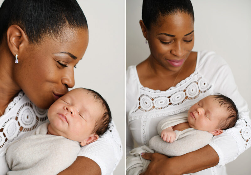 Black mom kissing and holding newborn baby in swaddle in Sacramento studio