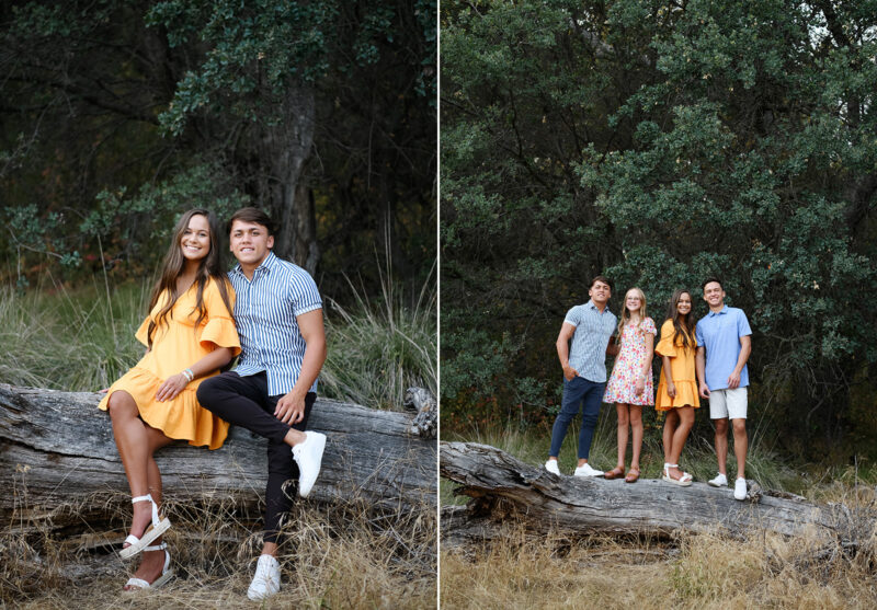 Siblings standing and sitting on fallen log surrounded by tall green trees in Folsom Lake