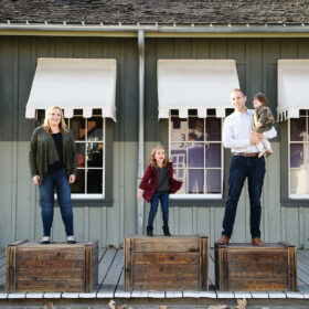 Mom, dad and sister standing on individual crates in Old Sacramento