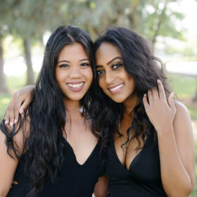 College graduate girls hugging and smiling in Sacramento State