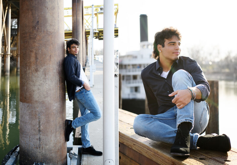 High school senior boy leaning against Sacramento waterfront pier and ferry