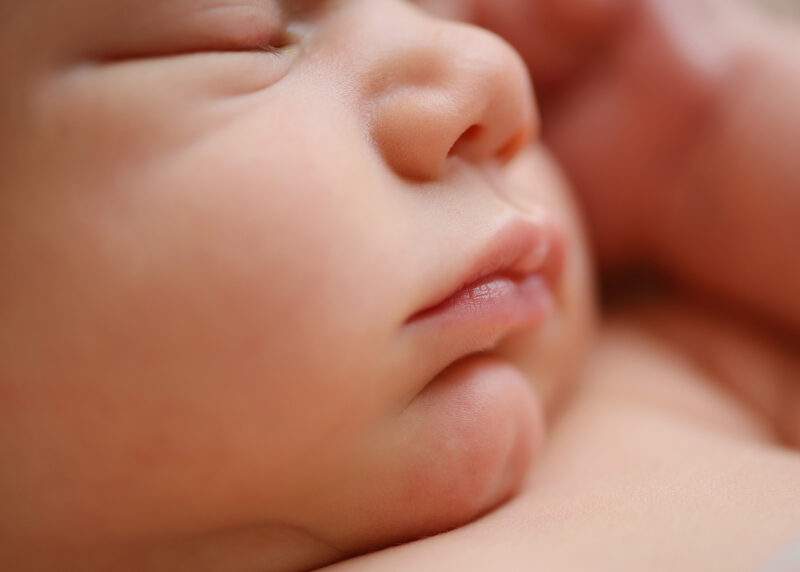 Sleeping newborn baby close up of mouth and nose 