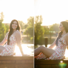 High school senior girl sitting down in front of Sacramento waterfront during golden hour sunset