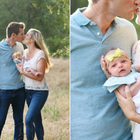 Mom and dad kiss while holding newborn baby girl in dry grass field in Rocklin