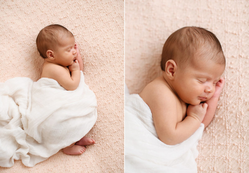 Newborn baby girl wrapped in white muslin sleeping on textured pink blanket in Sacramento studio