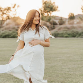 Pregnant woman wearing The Nines by Hatch from Target maternity dress on grass