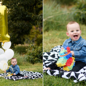 One year old boy sitting on checkered blanket holding a pinata with #1 balloons in Sacramento