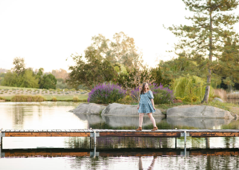 Teen girl walking along dock with water in background at Bywater Hollow Lavender Farm