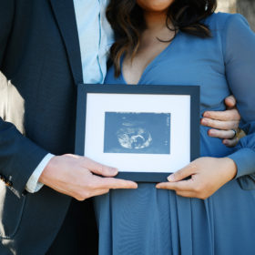 Pregnant couple holding a picture of ultrasound in Sacramento