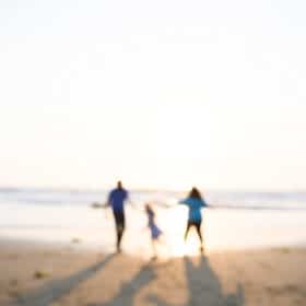 family holding hands on the beach at sunset dillon beach california