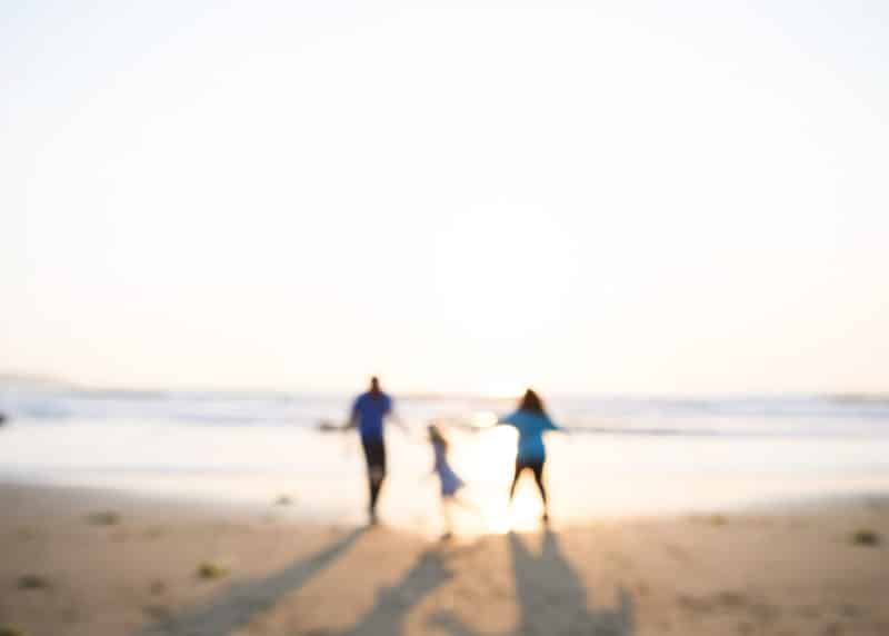 family holding hands on the beach at sunset dillon beach california