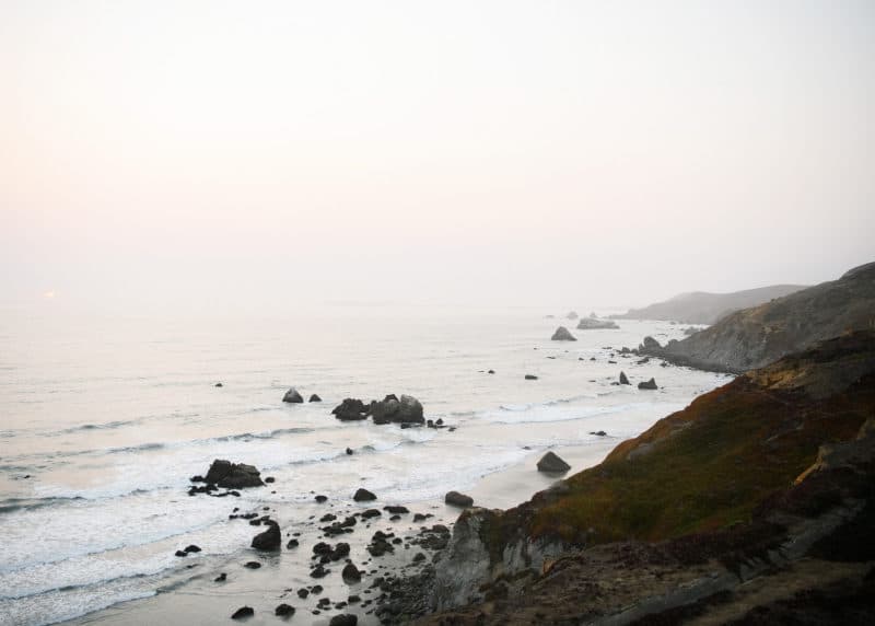 rocks on the ocean during sunset dillon beach california